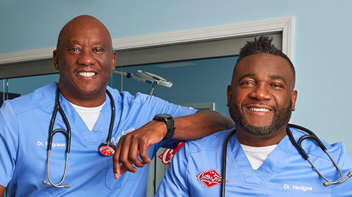 a couple of men wearing scrubs
