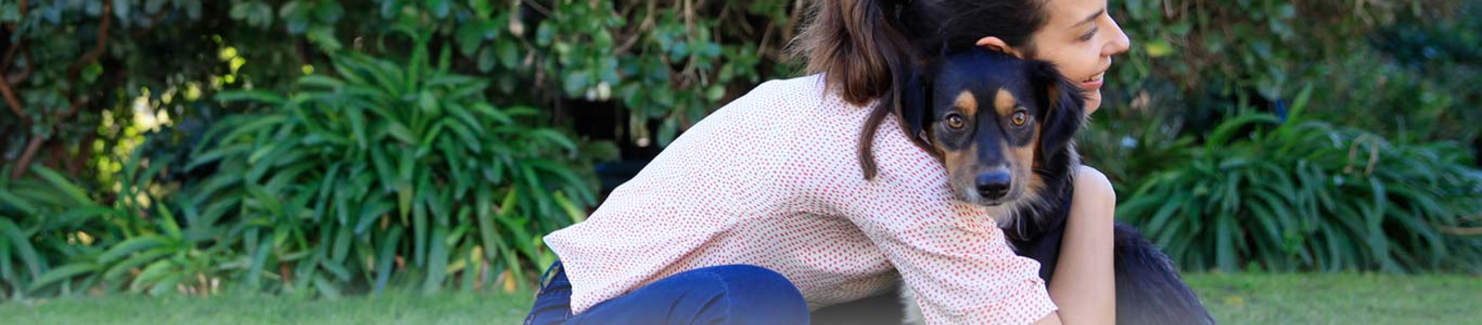 woman with dogs head on her shoulder